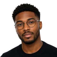 Man wearing OS GLADIATOR 10002 oval round metal prescription eyeglasses for men and women in black and silver, front view