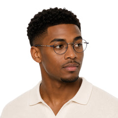 Man wearing OS GLADIATOR 10002 oval round metal prescription eyeglasses for men and women in silver and blue